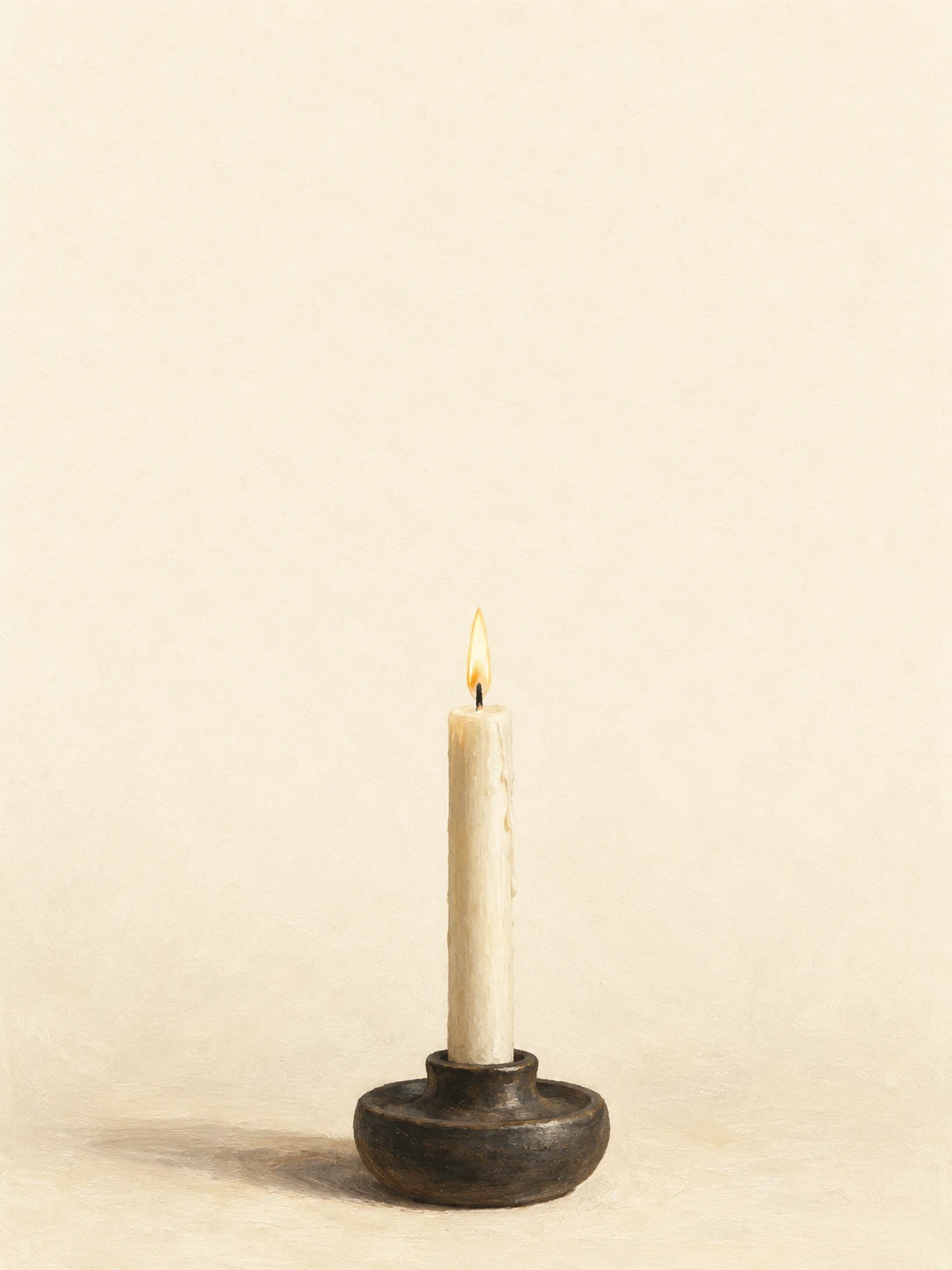 An ivory candle with a small steady flame in a dark ceramic holder.