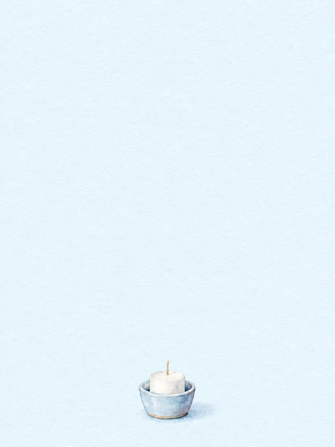 An unlit white candle sits in a pale blue ceramic holder.