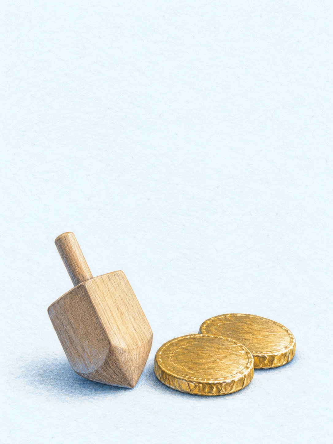 A plain wooden dreidel and two gold-wrapped chocolate coins on pale blue paper.