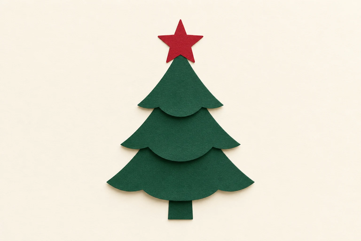 A small green paper Christmas tree with a red star.